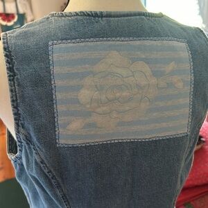 Upcycled denim vest with vintage fabric patch.